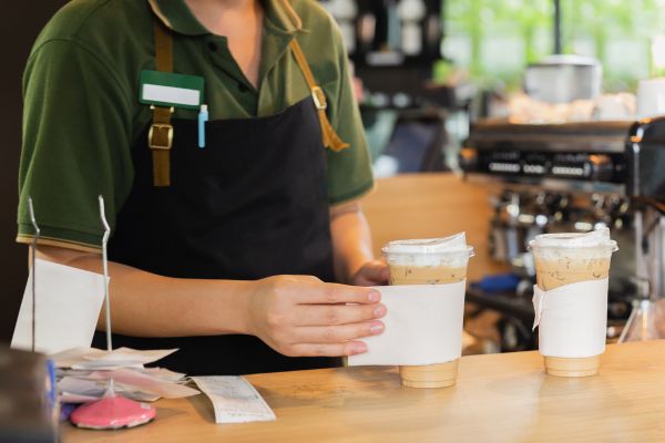 a person holding a cup of coffee